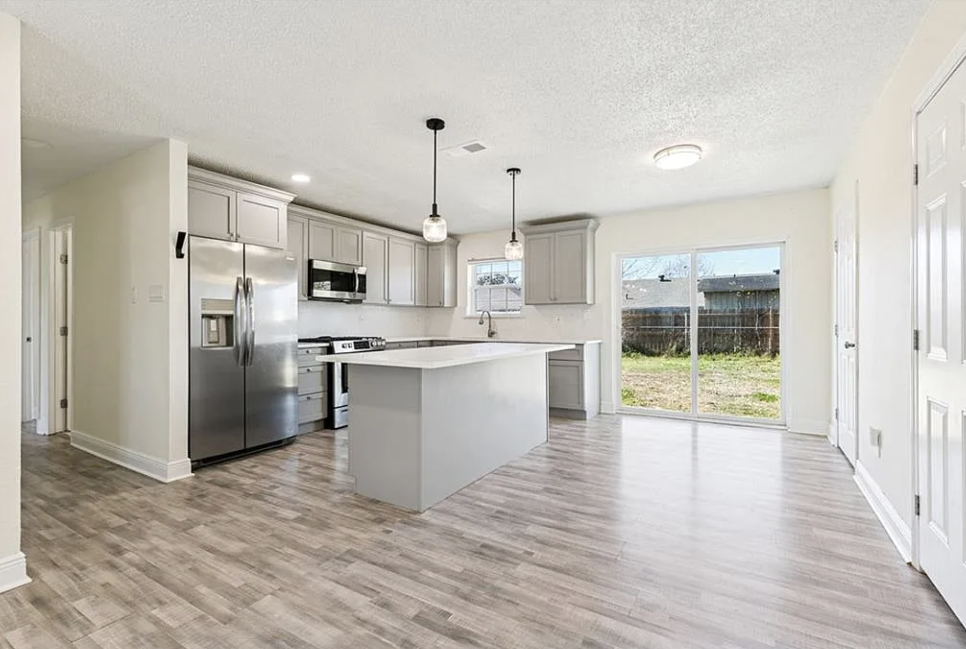 Updated kitchen with quartz island and stainless appliances